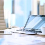 working place with laptop, digital tablet; graphs at the office