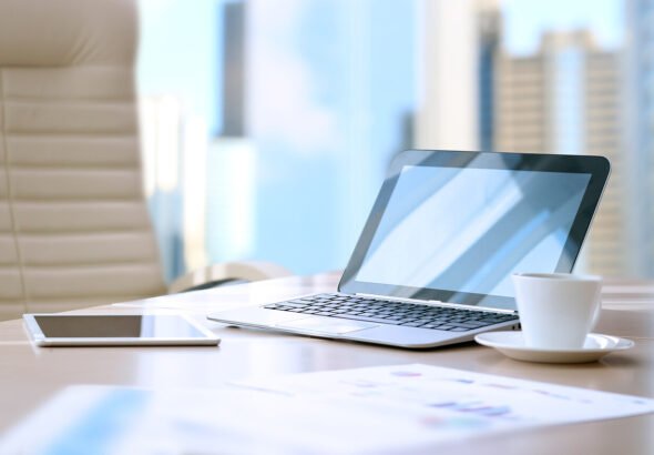 working place with laptop, digital tablet; graphs at the office