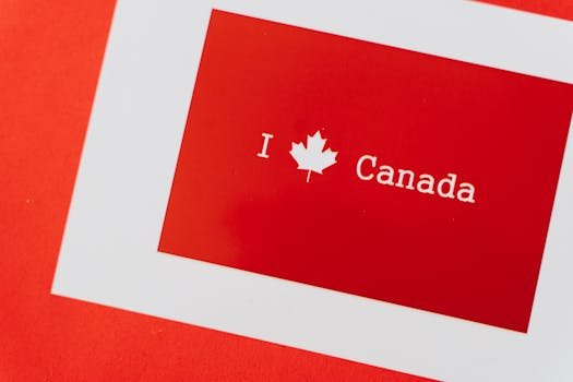 A red and white Canada-themed card featuring a maple leaf symbolizing national pride.